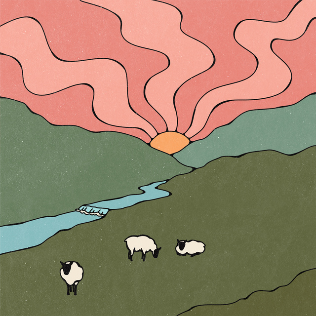 Three sheep in a field next to a river with the sun setting behind two mountains