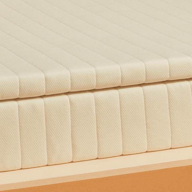 Close up of the mattress topper on top of a mattress
